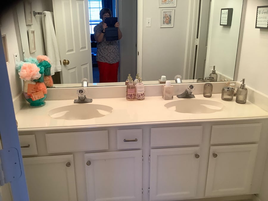 The bathroom has 2 sinks and lots of storage.