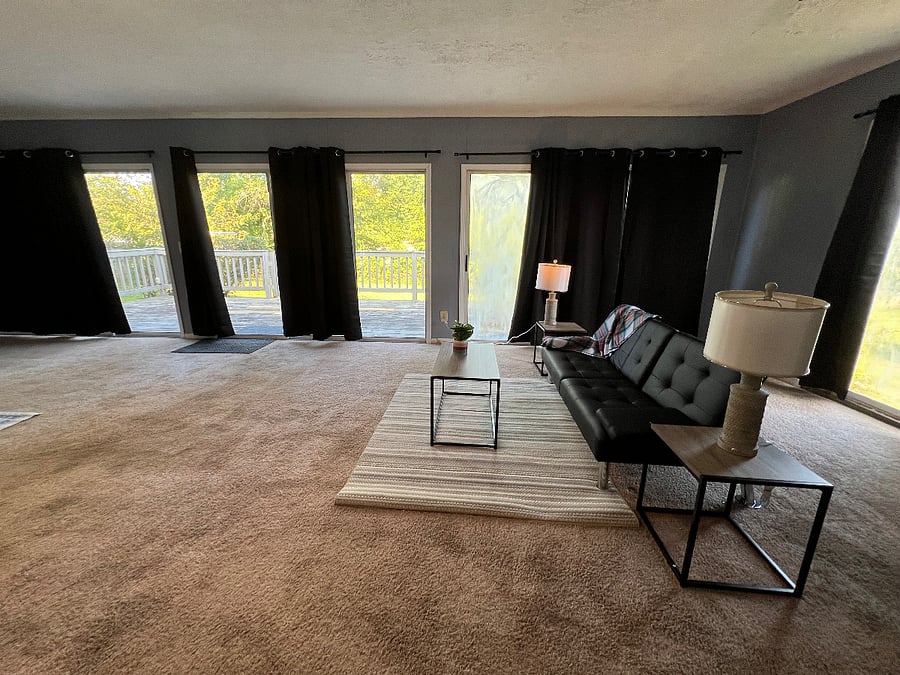 Bedroom #E - Very large bedroom with Queen bed, sitting area, desk n chair, lots of natural light walkout to backyard deck. Private entry thru garage.Shared kitchen, Dining and bathroom.