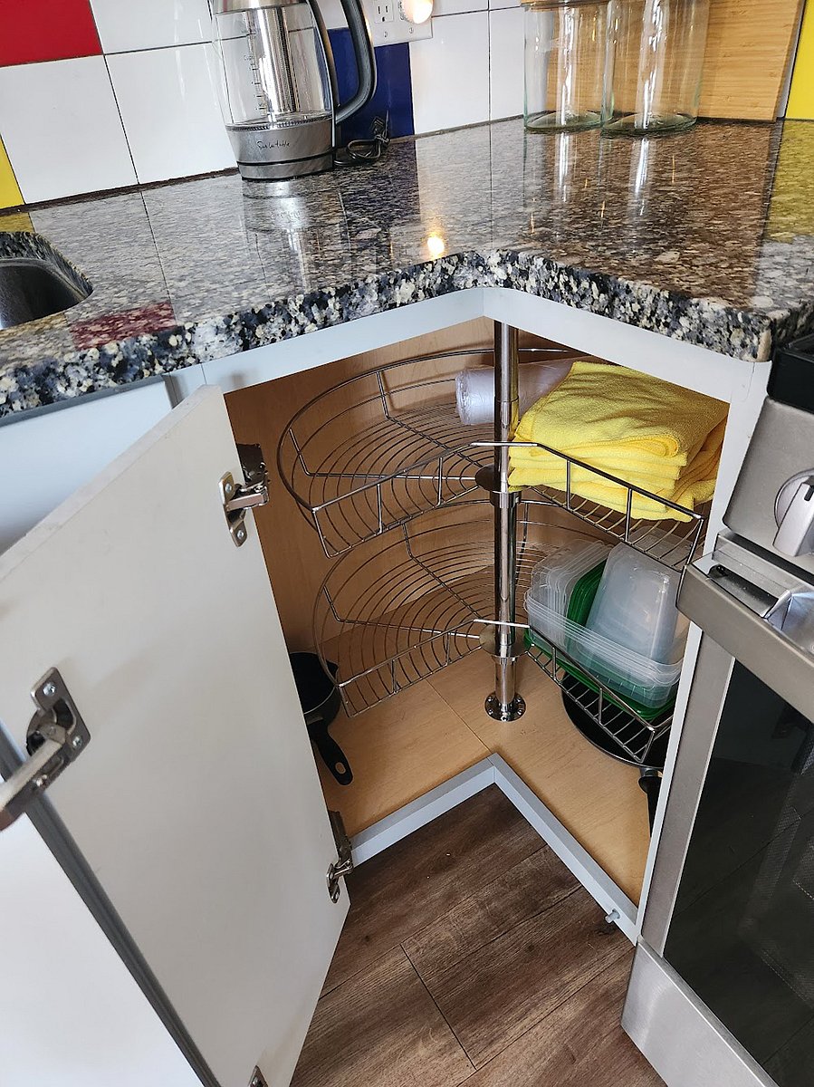 A lazy Susan in the corner kitchen cabinte provides additional storage