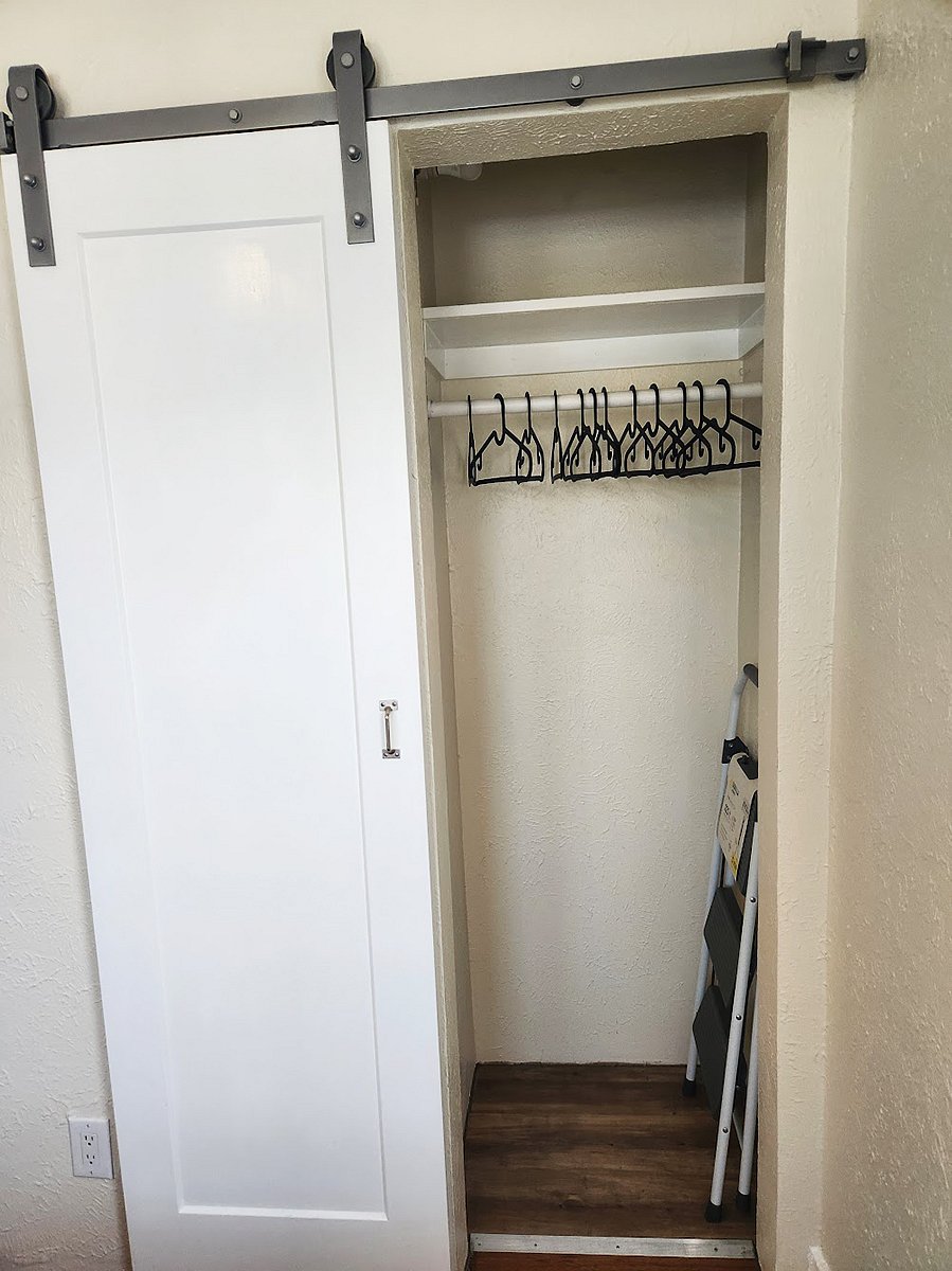 The bedroom closet comes with hangers and a shelf for extra storage.