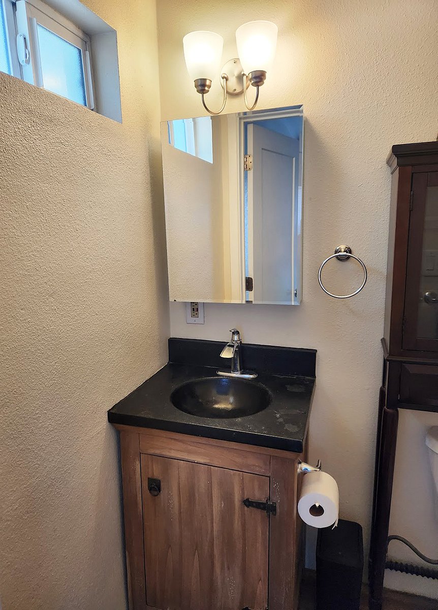 The compact, yet comfortable bathroom has storage in the vanity, the medicine and over-the-toilet cabinets.