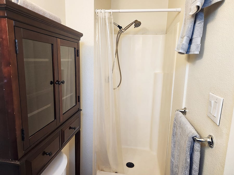 The bathroom has a tall shower with removable handle, and we provide two sets of fluffy cotton towels.