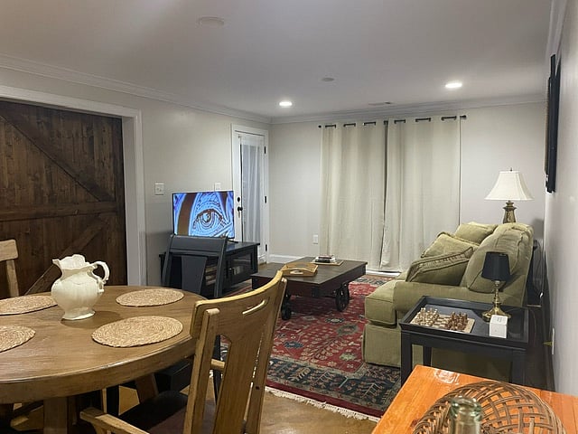 Living Room with Brand-New 50in Roku TV w/ cable, black out/sound proofing curtains and super comfy couch!
