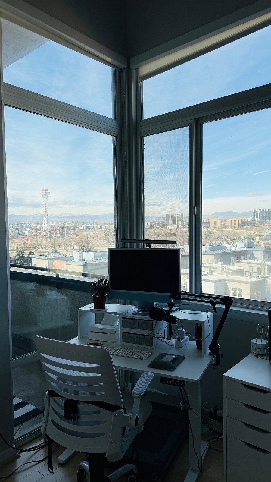 office sit/stand desk with floor to ceiling windows