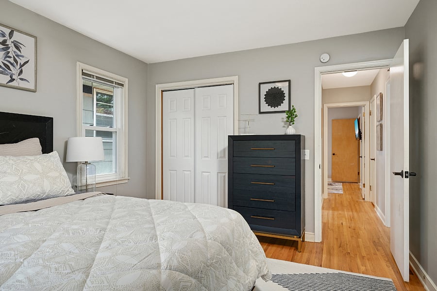 1st bedroom, main floor, queen bed, smart TV mounted on wall