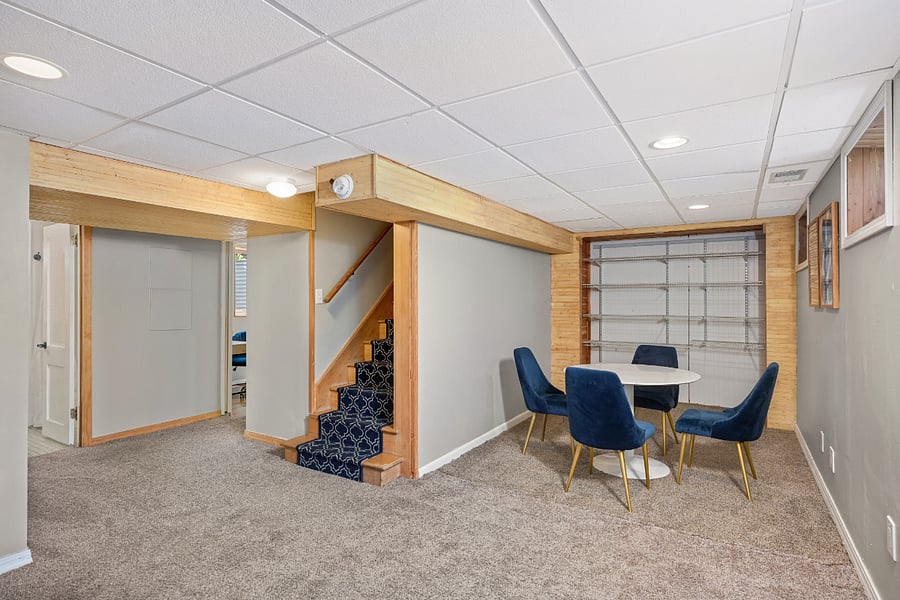 Lower-level family room, 55" smart TV on wall, area for games, studying or work from home