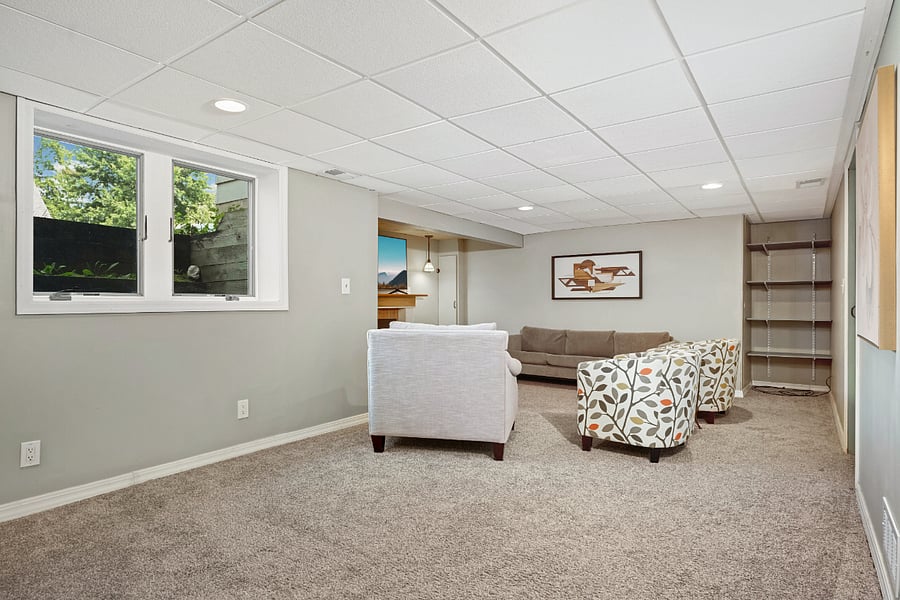 Lower-level family room, 55" smart TV on wall, area for games, studying or work from home