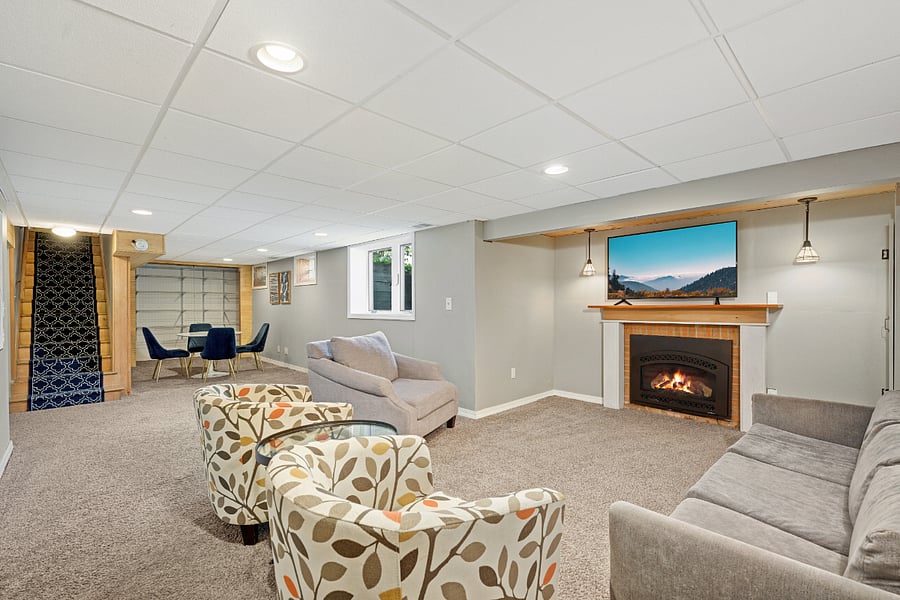 Lower-level family room, 55" smart TV on wall, area for games, studying or work from home