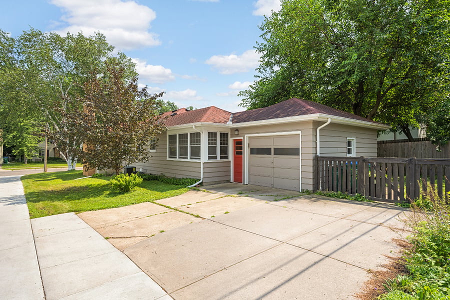 Exterior side, the house is on an alley, attached 1-car garage, driveway can accommodate 2 cars side by side