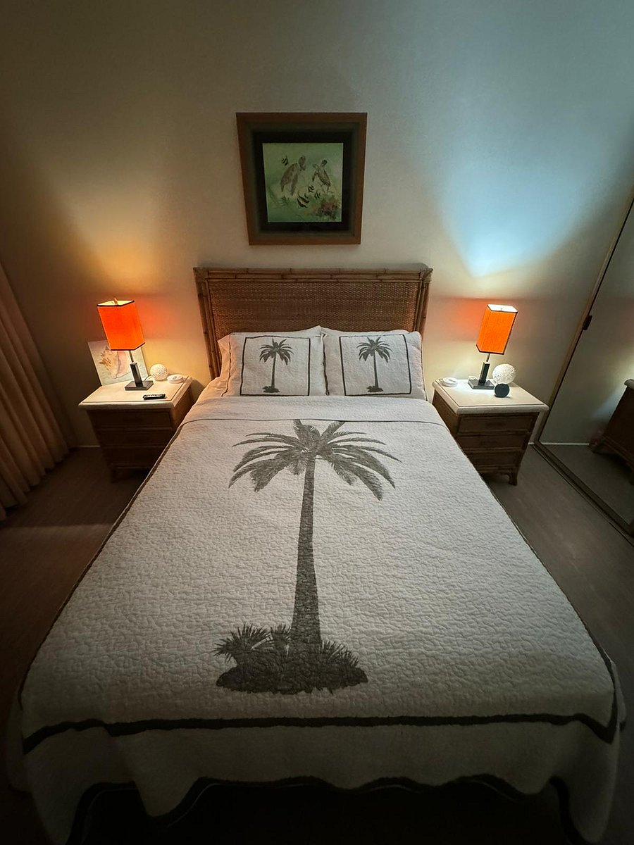Relaxing junior suite furnished with a palm tree theme and queen size bed, double mirrored closet, dresser, nightstands , blackout curtains and reading lights. Opens on to the lanai.