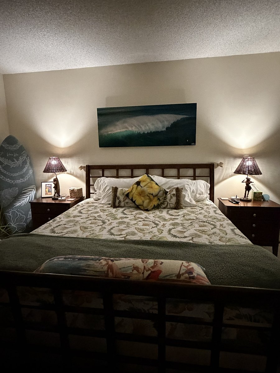 Primary suite furnished with a king size bed , double mirrored closet, dresser, nightstands, reading lights, blackout curtains, surf and hula decor.