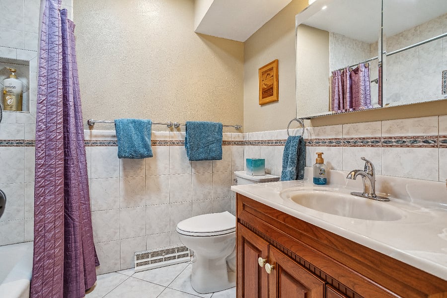 Hall bath with tub/shower on main level. There are 3 bathrooms in home. Each bedroom has adjoining bathroom and there is this full bathroom off hallway.