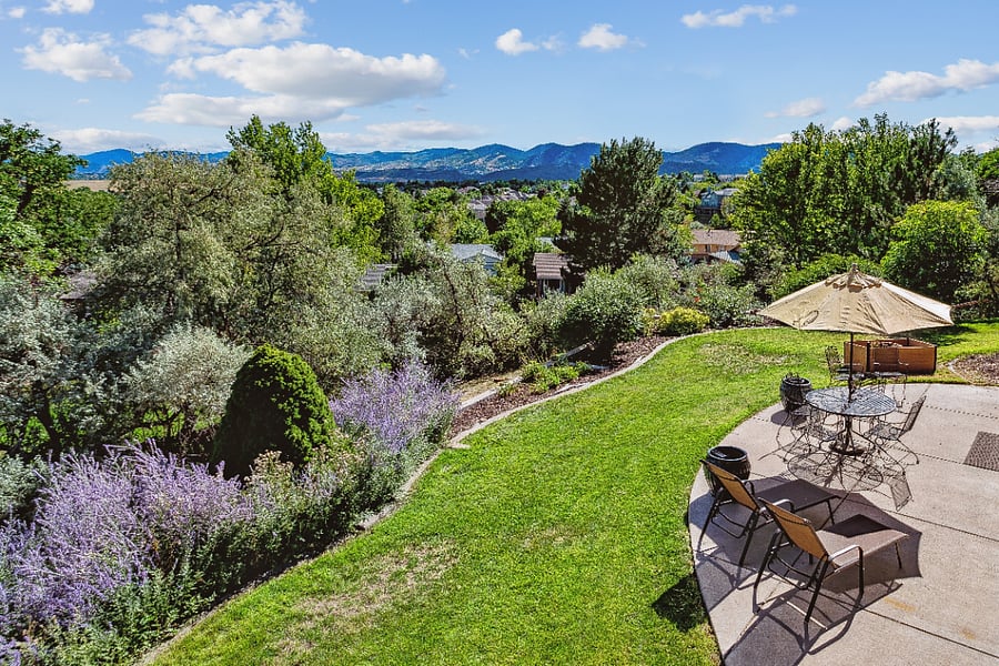 Upper level of backyard with large patio & gas grill.