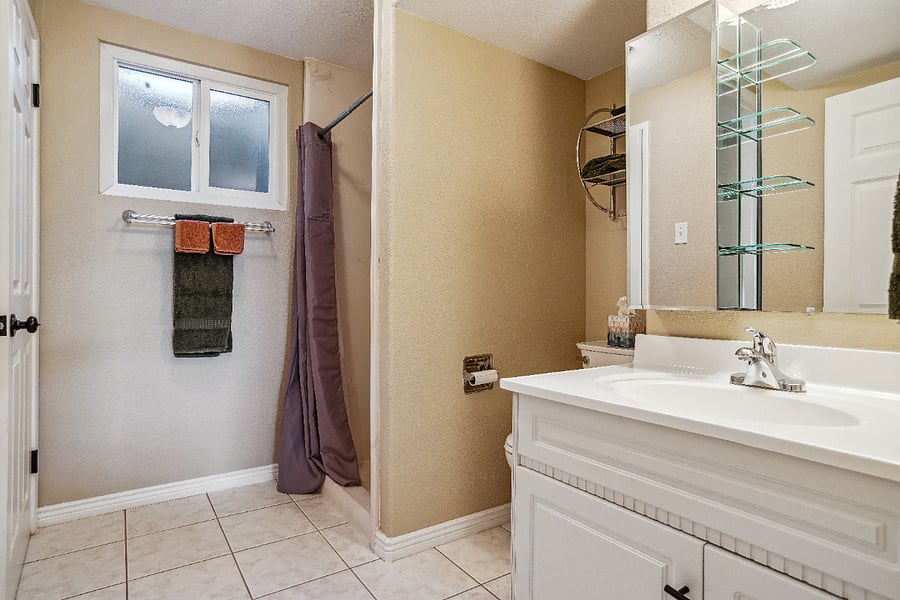 Adjoining bathroom with shower to king sized bedroom. Located on sunny walkout basement level.