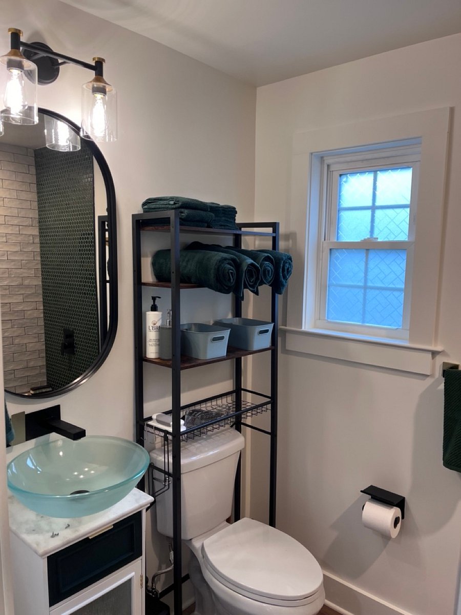 Small but mighty bathroom space.  limited under sink storage, but extra over the commode storage.  The bathroom pocket door and bathroom window allow lots of natural light.