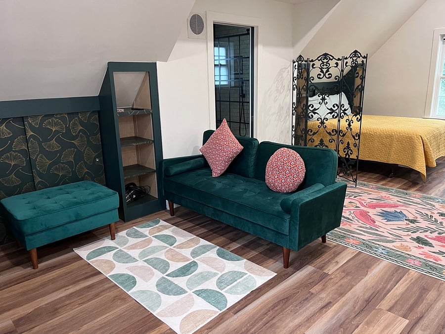 Living room area across from the kitchenette, outfitted with pass through closet as well as extra built-in shelving for extra storage space.  