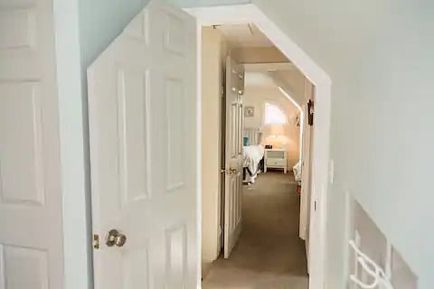 Through the door you can see the hall, with the bathroom in the hall and the second bedroom straight ahead.