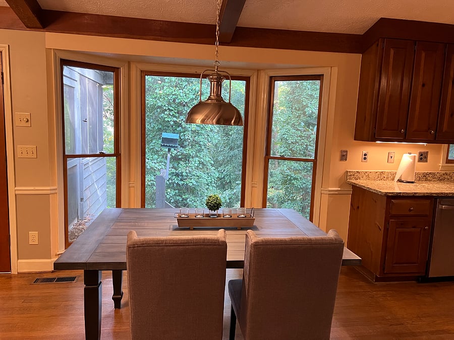 Breakfast table overlooking wooded back yard