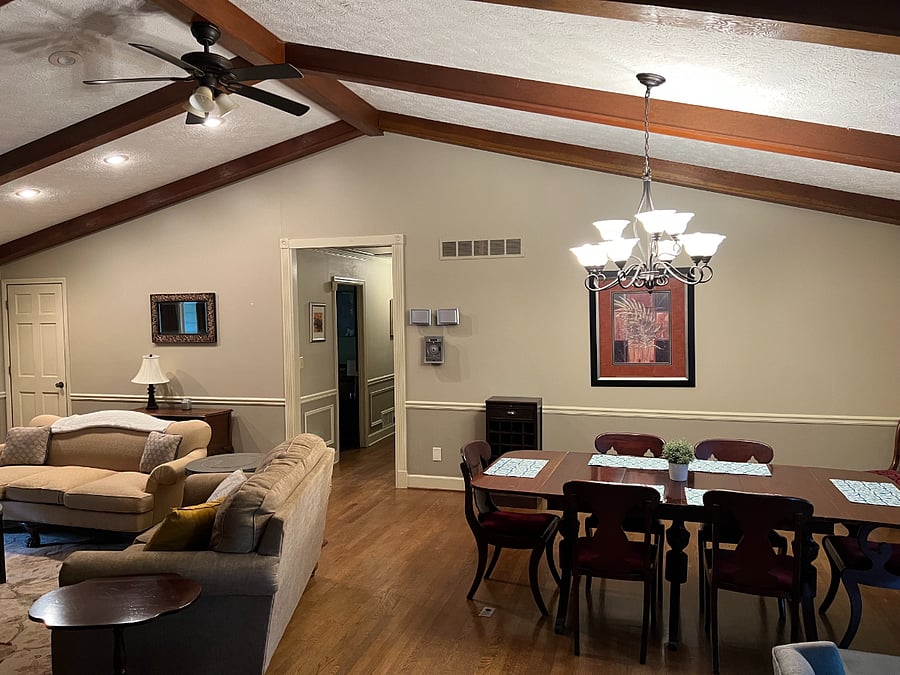 View of living room and hallways - high vaulted ceiling with plenty of open space.