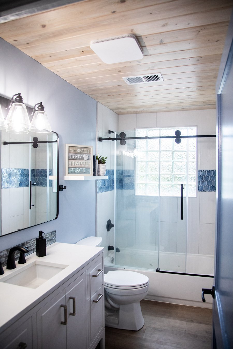 Bathroom features a tankless hot water tank, high pressure shower head, cypress ceiling and automatic humidity fan
