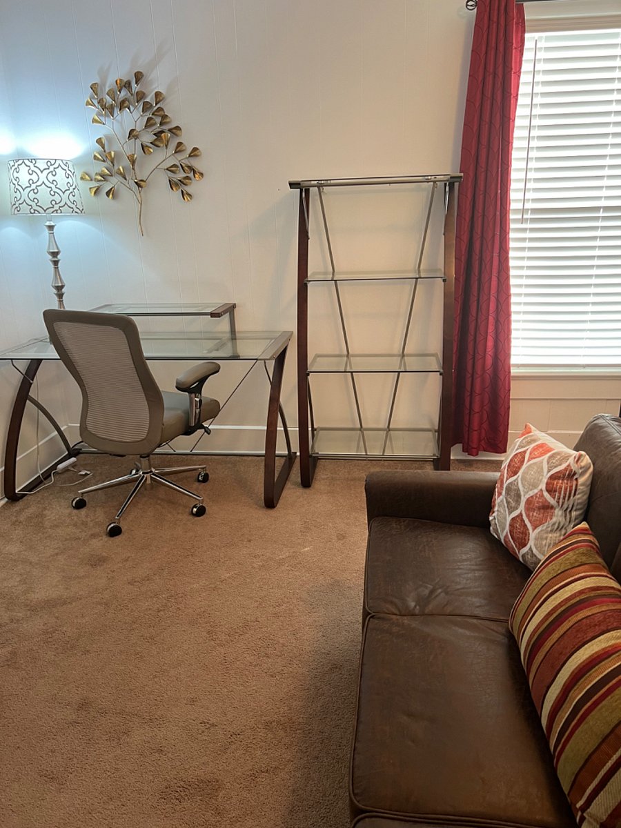 Desk and bookcase.
Second bedroom shared with study/TV room.