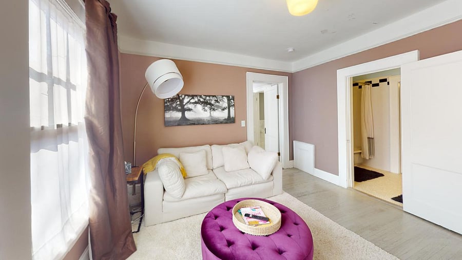 TV Room with coach and ottoman with pictured access to Front Bathroom and Master Bedroom