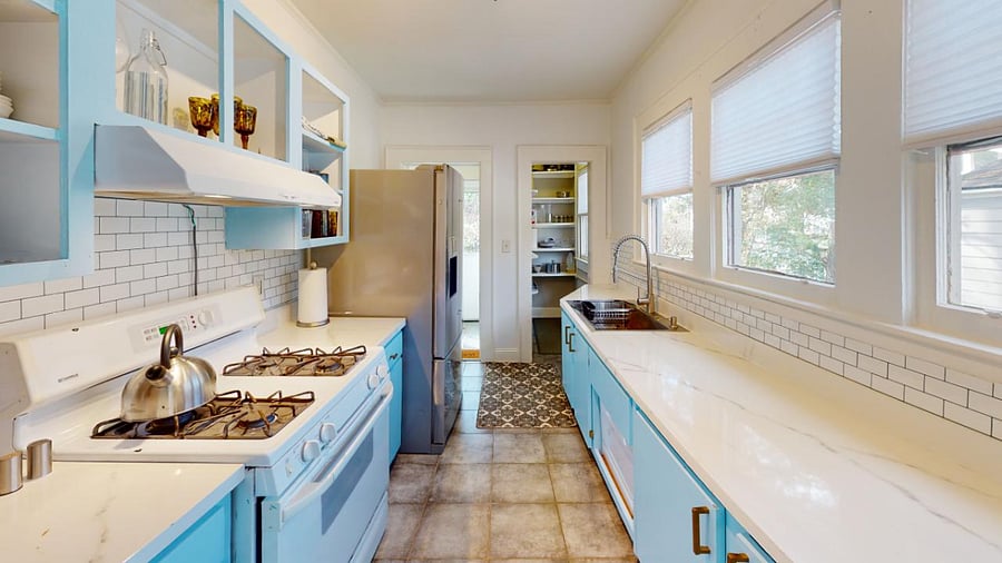 Furnished Kitchen with lots of pots, pans, plates, small dishwasher and more