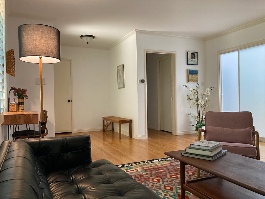 Front door on left and door to bedroom hallway on right.