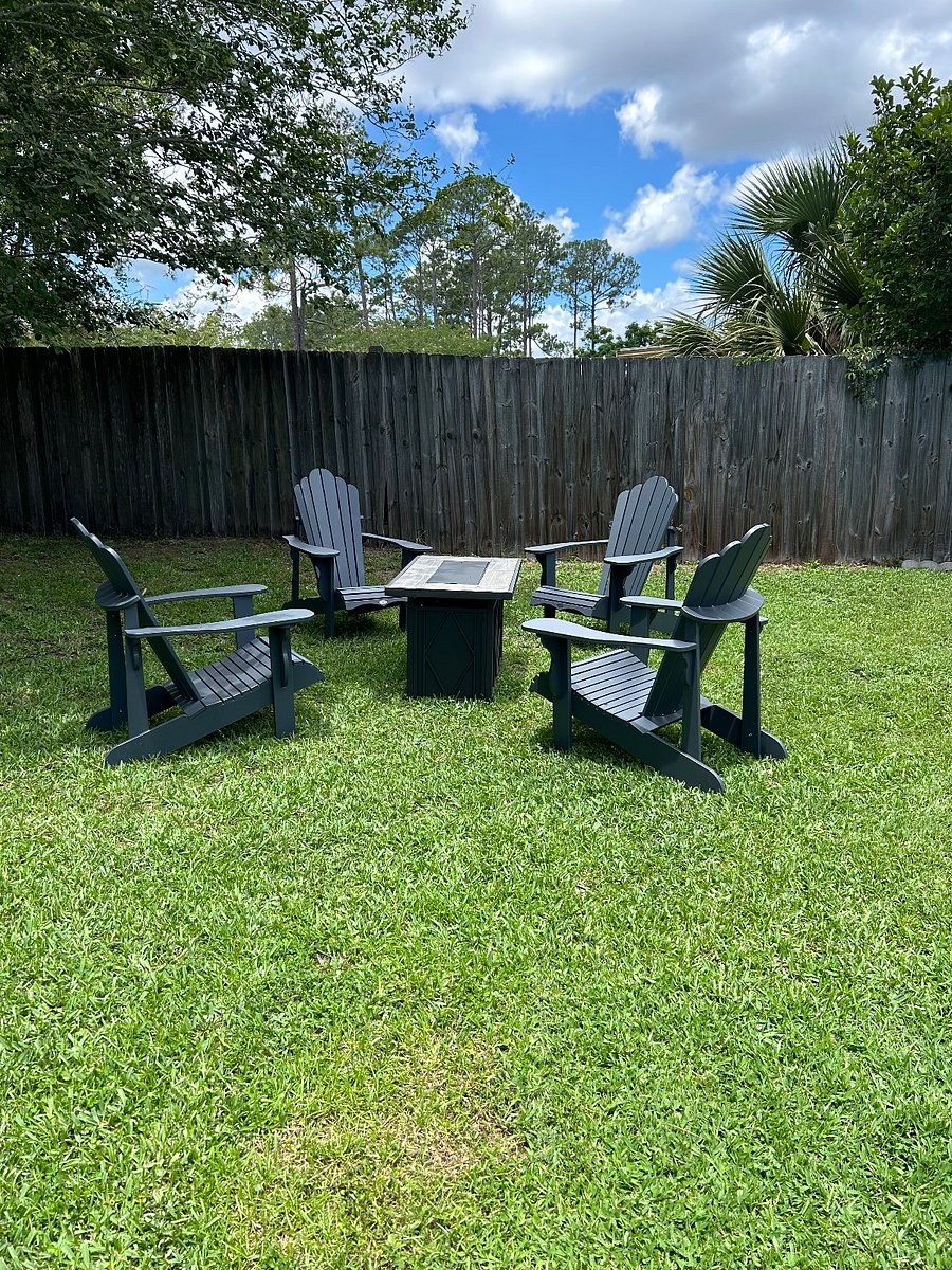Fire pit with Adirondak seating in private fenced in back yard.