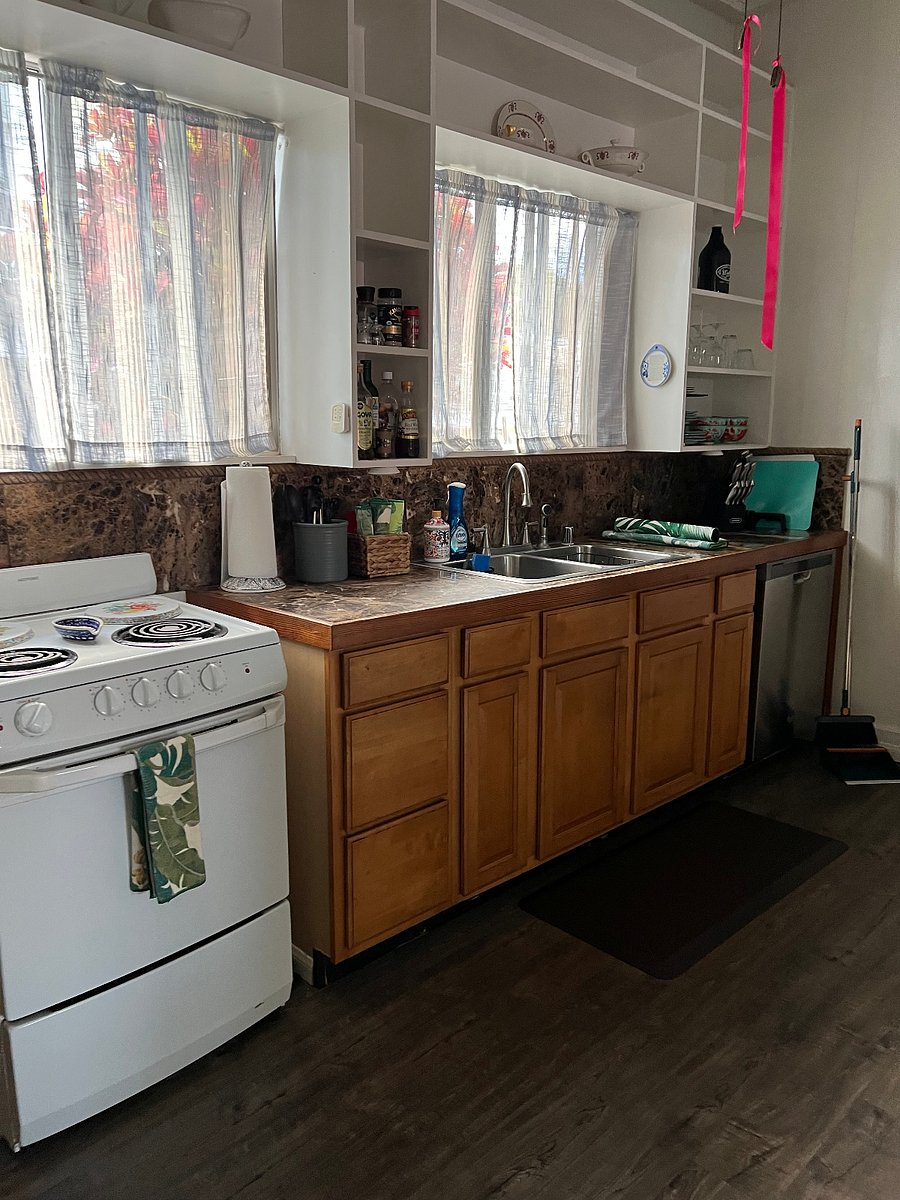 A  full size kitchen: full size refrigerator, stove, and dishwasher.