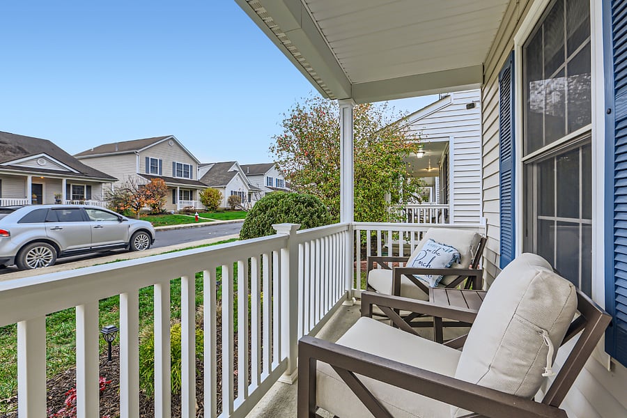 Porch seating area with table and rocking chairs- come sit on the porch!