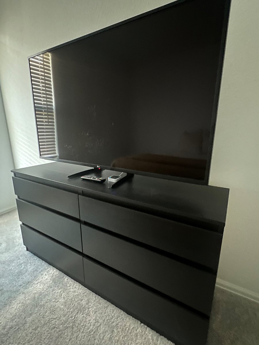 40 inch Smart TV on top of empty dresser.