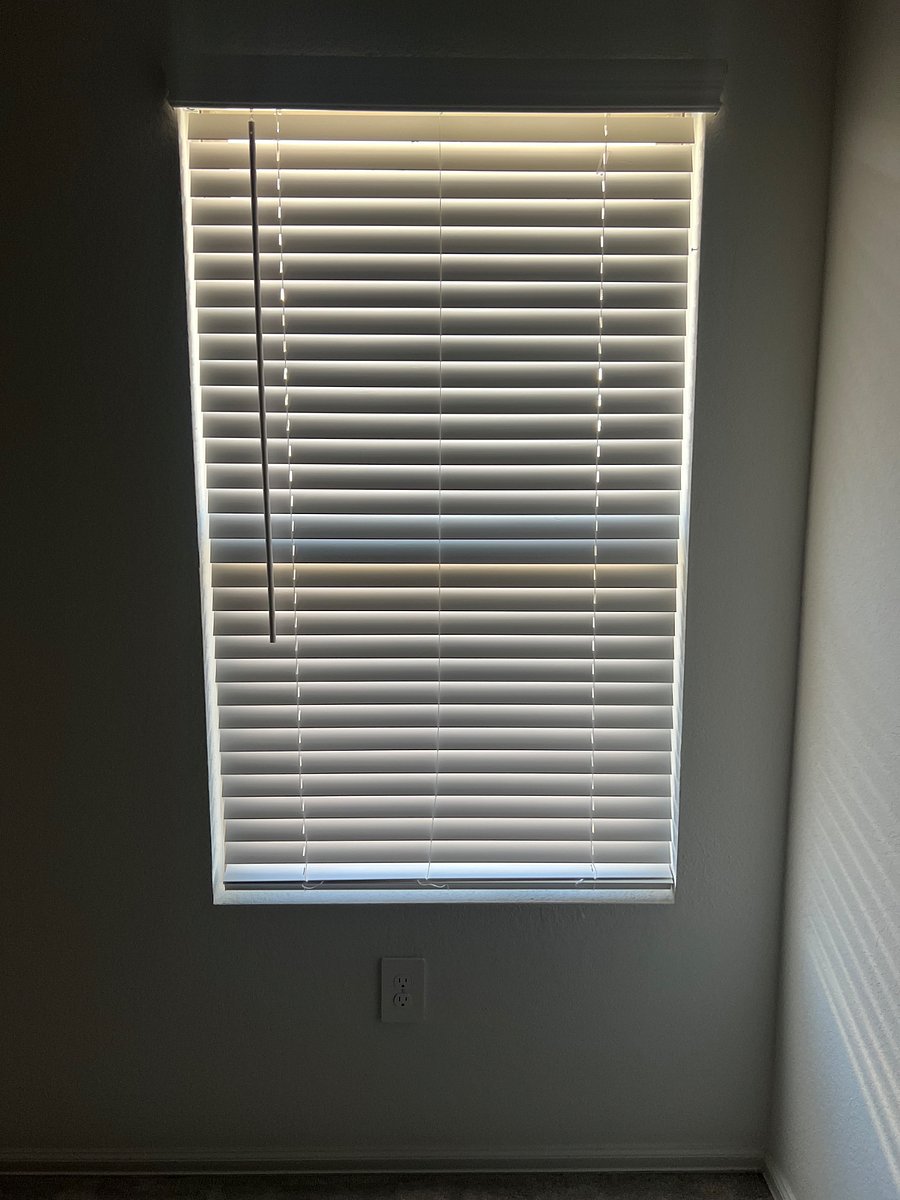 Picture of window with blinds, we can place a curtain for you upon request.