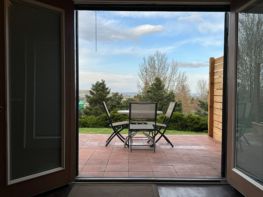 View of surroundings and patio from kitchen. This is the entrance to the Apt.