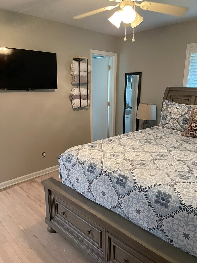 Master bedroom w/ door to private bathroom