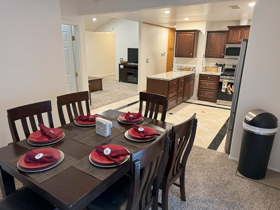 Dining Room Table seats 6 comfortably. There is a leaf underneath should you need to open. This room has double french door leads to left side of backyard
