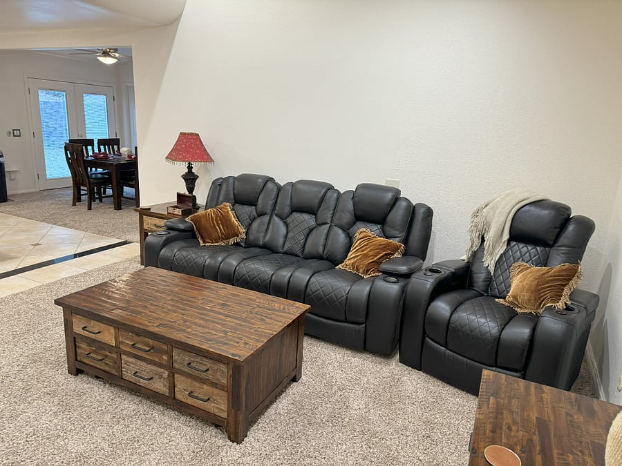 Black Leather 2 Recliners and center comes down to a table with plugins. Separate Black Recliner Chair with Dual cup holders