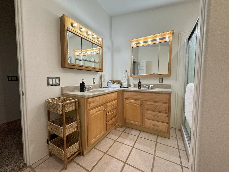 Master Bathroom has 2 individual Vanities with their own Mirrored Medicine Cabinets, 3 Tier Wicker Basket Storage