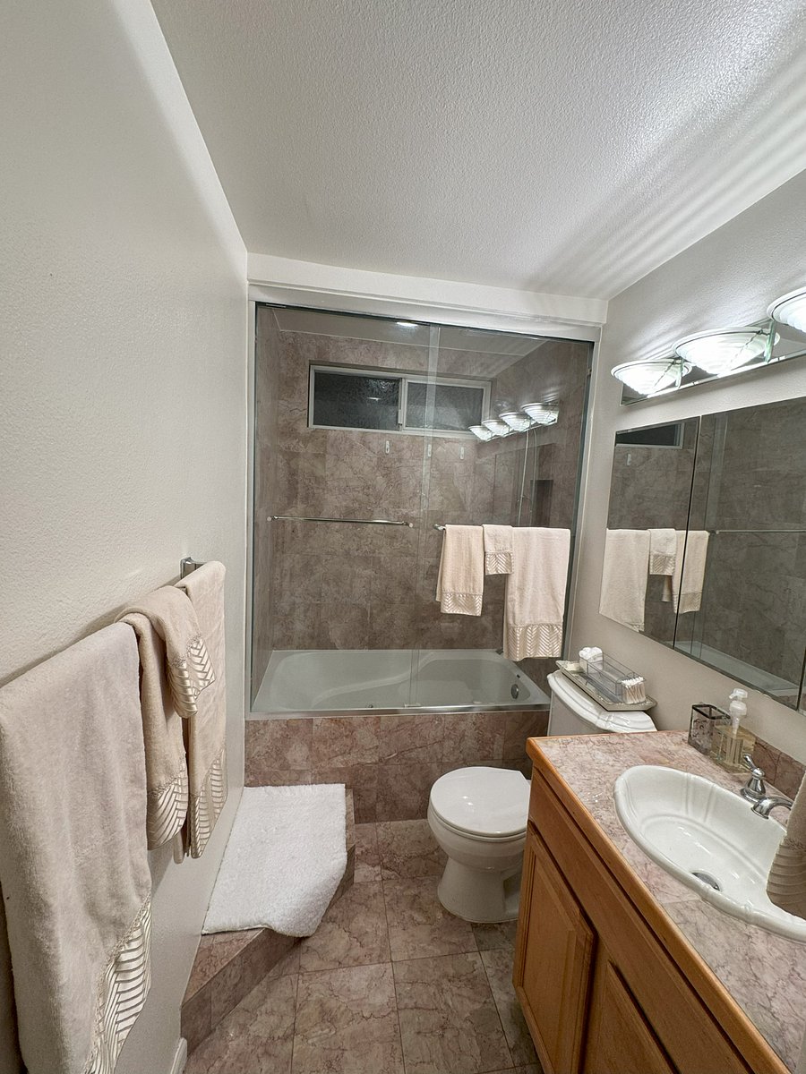 Guest Bath Jacuzzi Tub / Shower. Marble Tile inside Showers, Counter, Floor