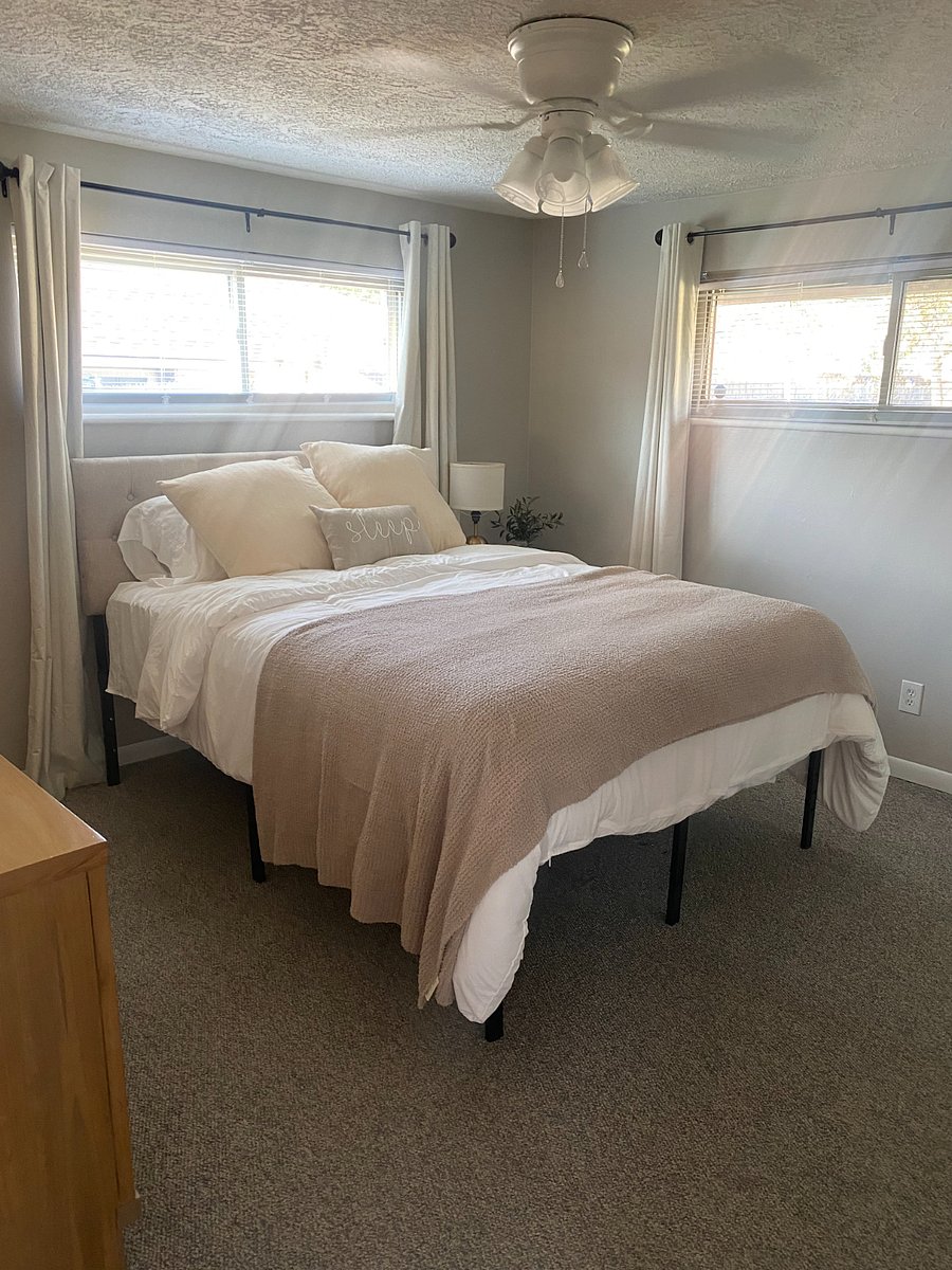 Master bedroom with queen bed, 50 inch smart TV and full dresser.
