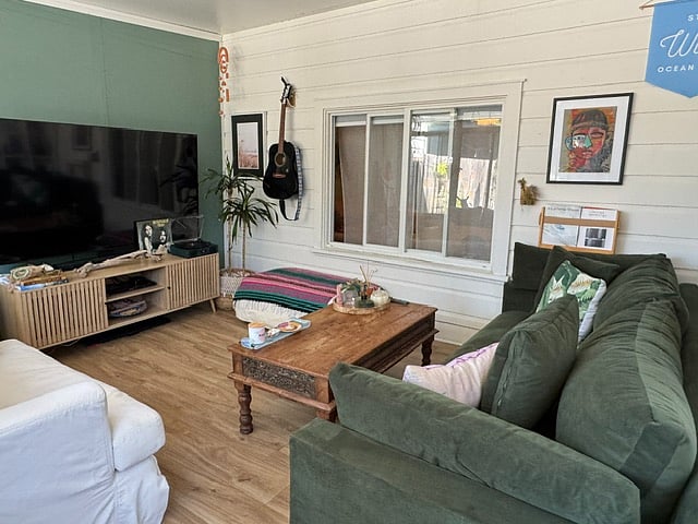 Sunroom with vinyl flooring (window on right is where the bedroom is located). 