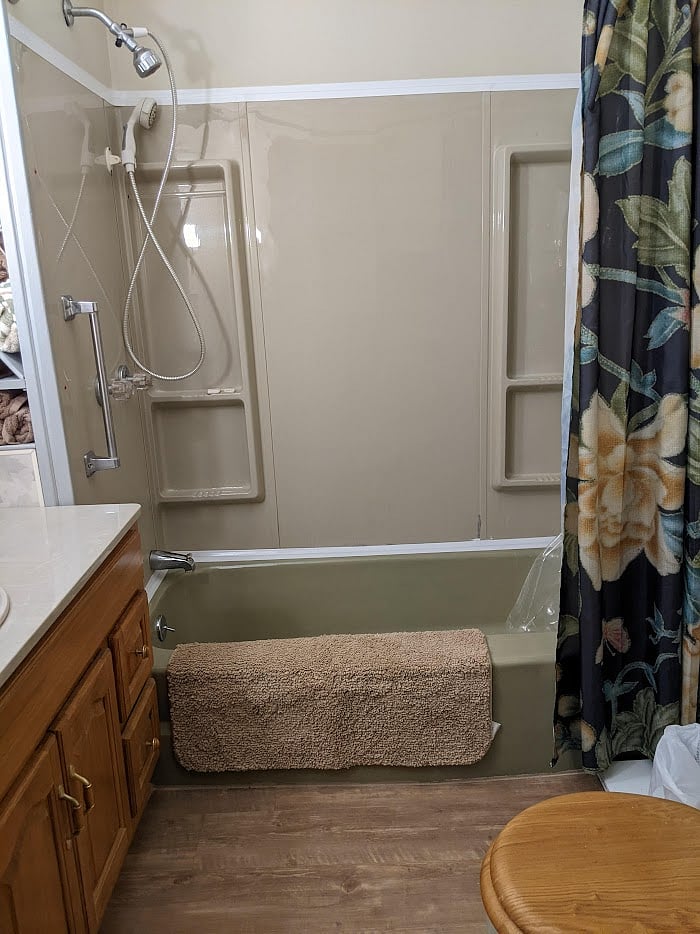Full tub and shower in the bathroom.