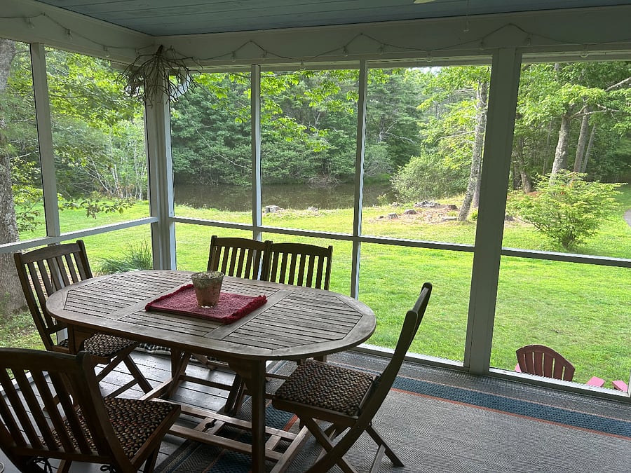 Screen porch overlooking pond and side yard
