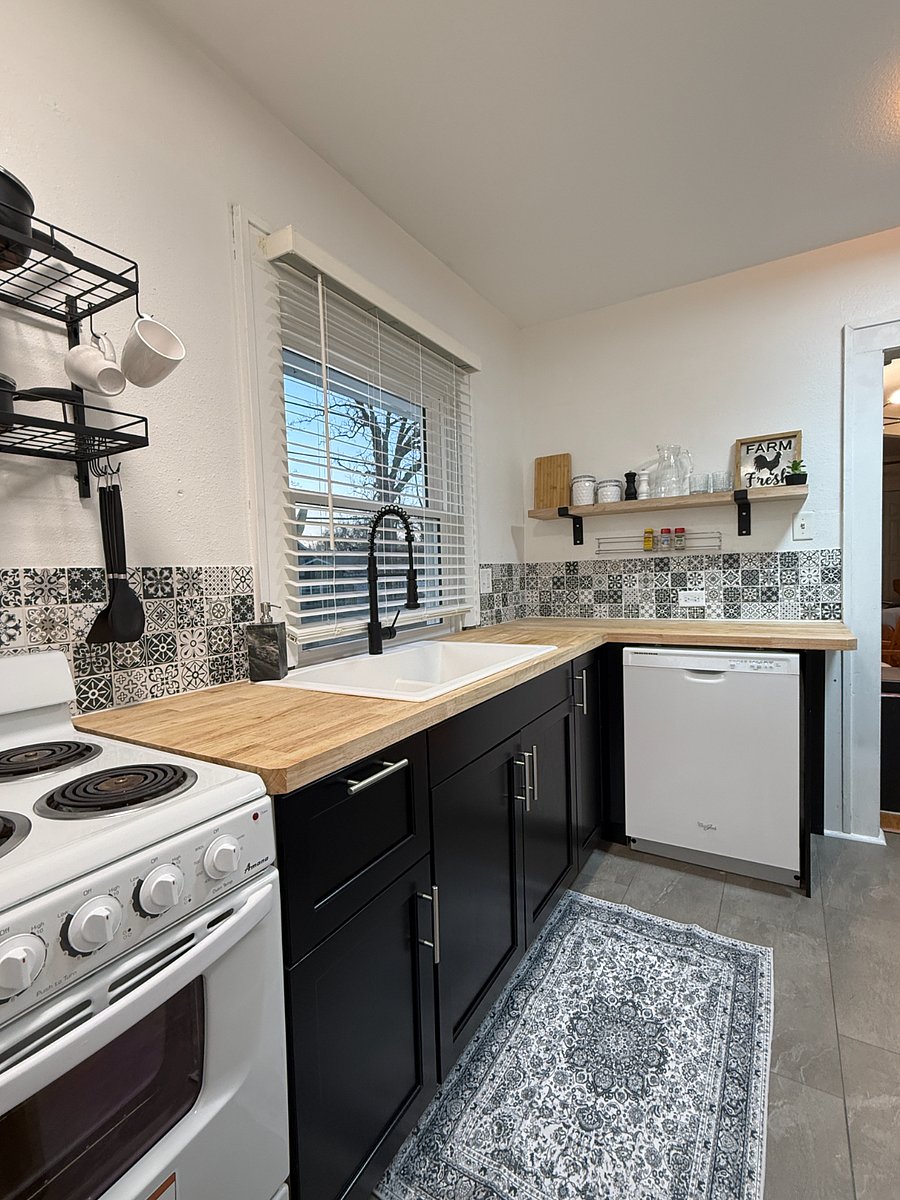 Open shelving for easy access with plenty of storage in lower cabinets and a dishwasher for your convenience.
