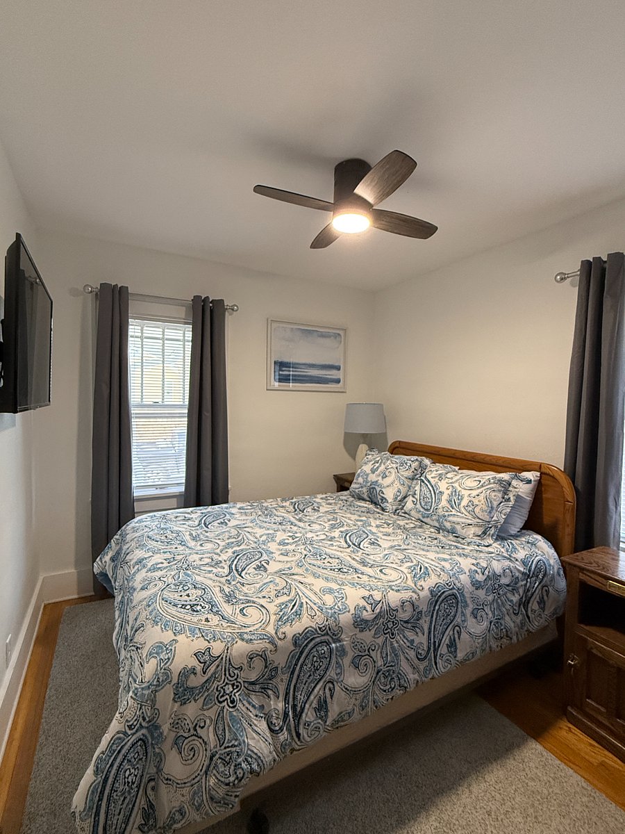 Primary bedroom with queen size bed and Roku TV.