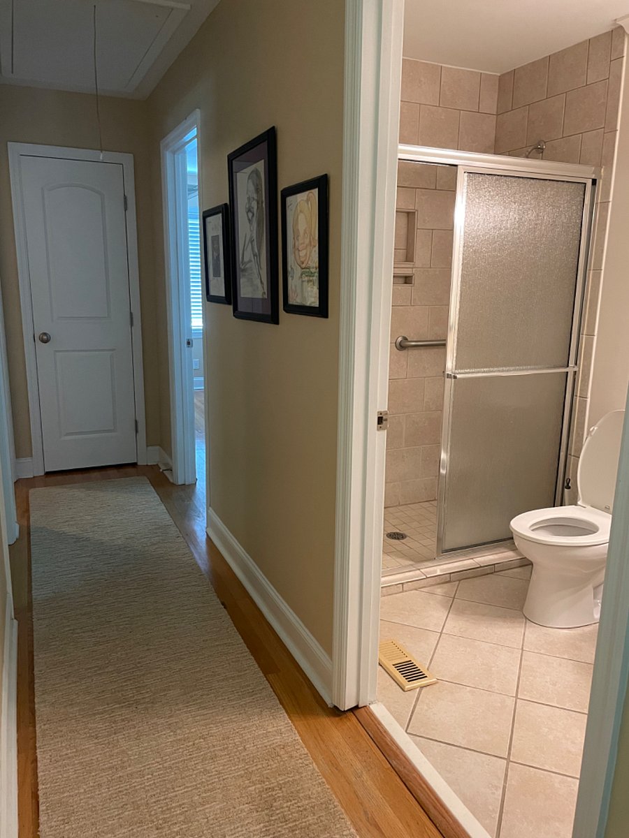 Hallway showing entrance to hall bath on the right. The master bedroom is the last door on the right, and the second bedroom is the last door on the left. At the end of the hall is a linen closet.
