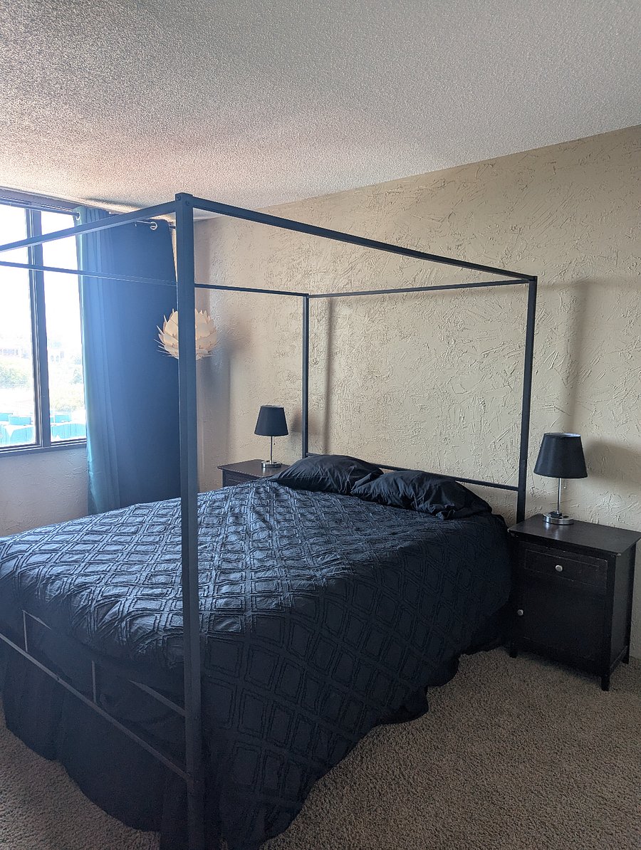 Large bedroom with Queen bed and blackout curtains