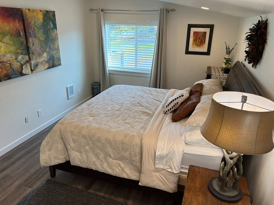 First bedroom with south facing window that includes blinds and blackout curtains