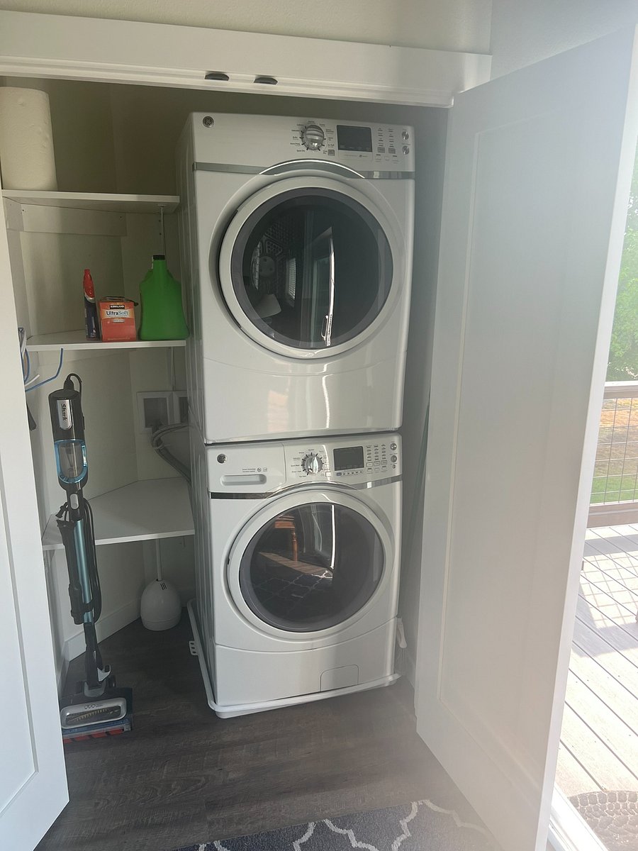Full size stacking washer/dryer in unit.  Located in closet