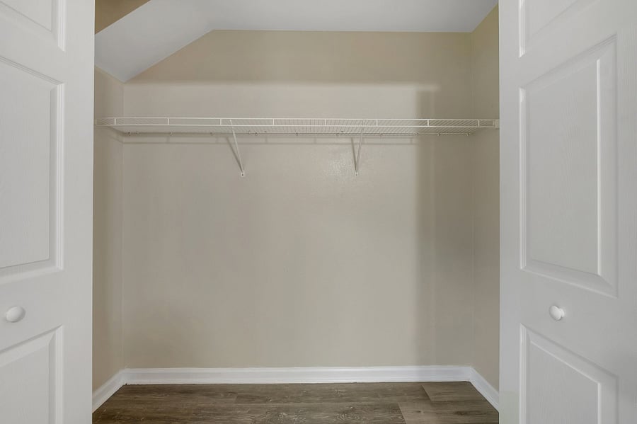 Unpack with ease in the spacious walk-in closet with built-in shelving.